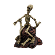 Creepy Skeleton Sitting On Rocks Statue Figure Image 1