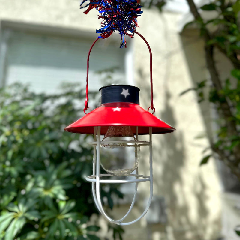 Rustic Metal Red, White, and Blue Patriotic LED Hanging Solar Lantern With Cutout Stars for Beautiful Indoor and Outdoor