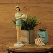 Graceful Brunette Retro Bathing Beauty Figurine – Sage Green & Light Blue Striped Swimsuit, Holding Beach Ball, Hand-Painted